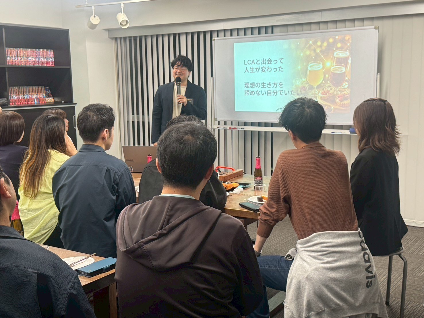 室内で参加者に向けて話している場面
